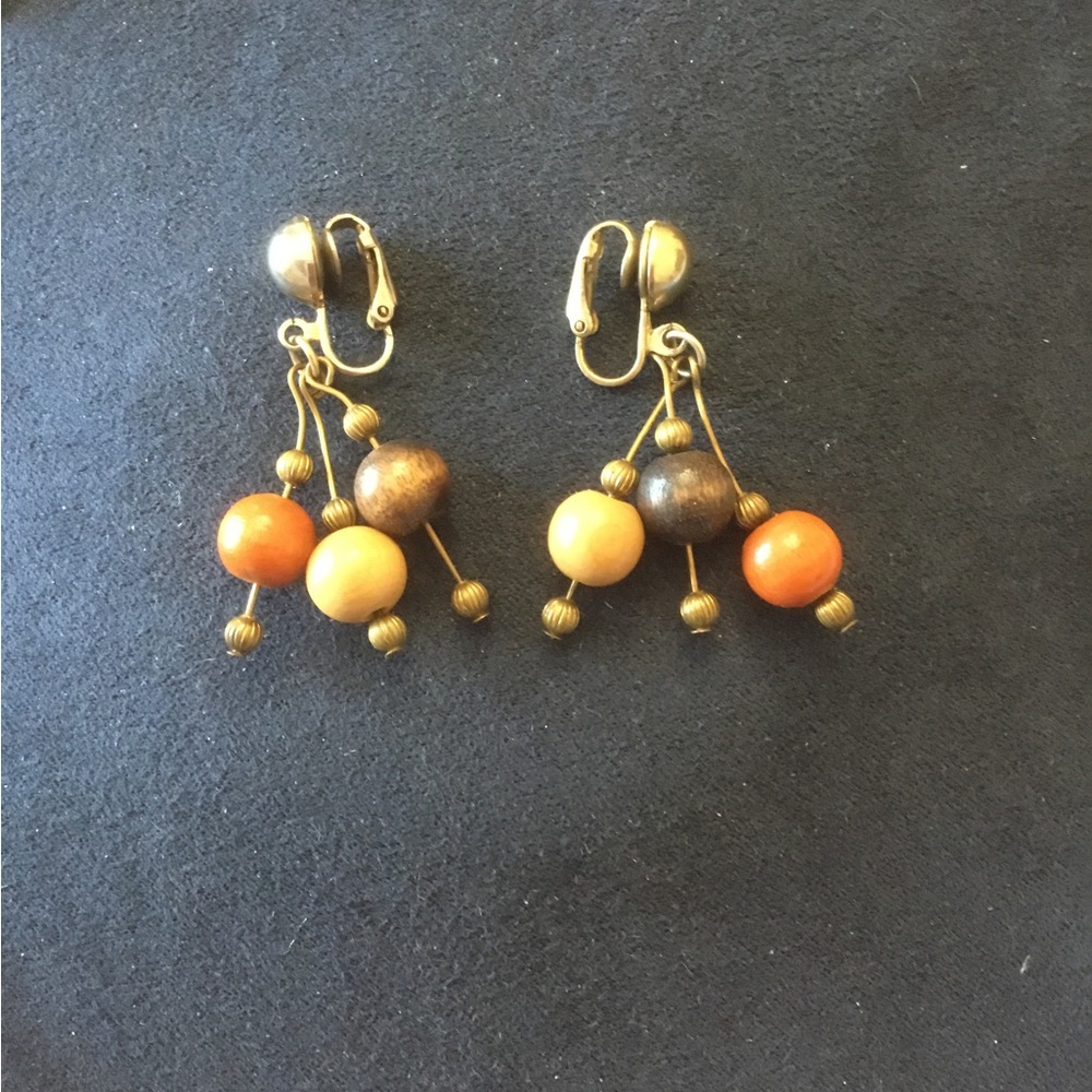 Fabulous clip on gold tone drop earrings of orange, tan&brown wood & gold beads